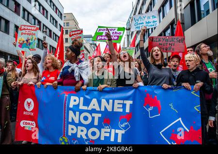 Protesters chant slogans against climate change during the climate demonstration march. Thousands of people gathered at the Brussels North station to protest against the lack of action on the climate crisis, during a climate march organized by The Climate Coalition (a national non-profit organization that unites more than 90 organizations around the theme of climate justice). With this march, they demand to fight the energy crisis with a single energy policy between the Regions and the Federal State which allows Belgium to achieve 100% renewable energy before 2050, and to fight against the agr Stock Photo