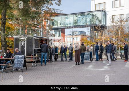 People queuing for the burgers from Funky Chicken food truck at the square Augustendalstorget in Nacka, Sweden. Stock Photo