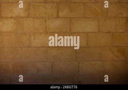 Old yellow stone wall background Stock Photo