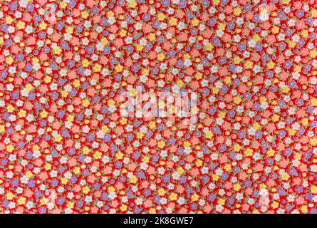 Close up on a high detailed photograph of a Japanese furoshiki cloth made in cotton fabric with a pattern design illustrated with colorful flowers enh Stock Photo