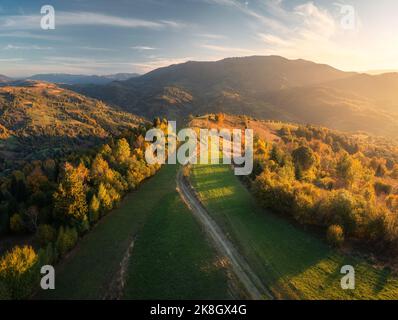 Aerial view of green hills, forest and mountains in autumn Stock Photo