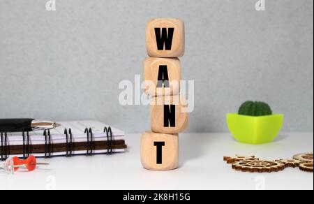 text the word want from gray wooden small letters with black font on an red table Stock Photo