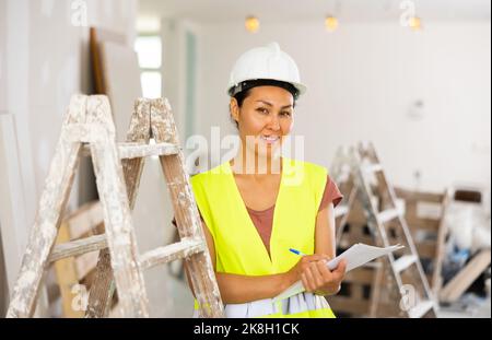 Woman construction worker with project documentation Stock Photo