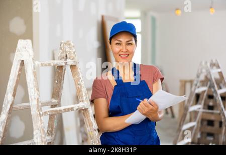 Woman construction worker with project documentation Stock Photo