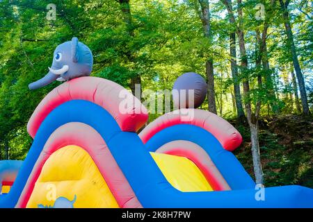Detail of a brightly colored bouncy castle, empty without children. Stock Photo