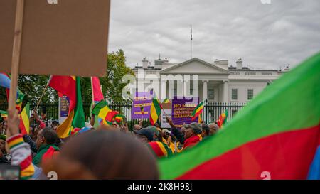 Washington, United States. 23rd Oct, 2022. Ethiopian demonstrators gather in front of the White House to protest US intervention in the ongoing war in Ethiopia. Part of the DC-Ethiopian community gathered in front of the White House to protest US intervention in the ongoing war in Ethiopia (between the federal government and the Tigray People) and biased media reporting on the conflict. At the rally, demonstrators were dancing and singing to traditional Ethiopian music. Credit: SOPA Images Limited/Alamy Live News Stock Photo