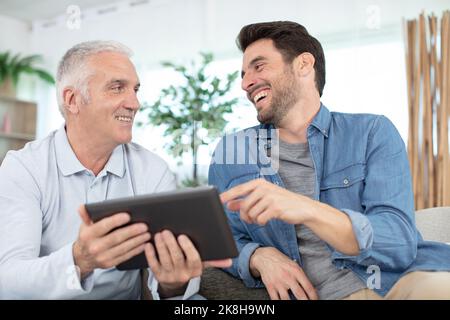 senior father and young son with tablet Stock Photo