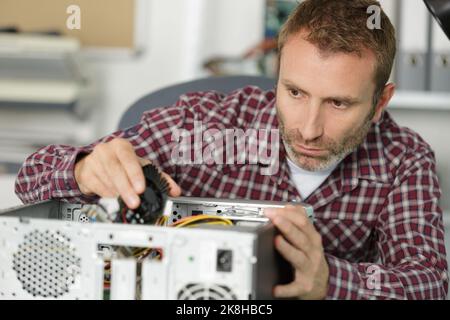 computer repairman specialist repairing computer desktop Stock Photo