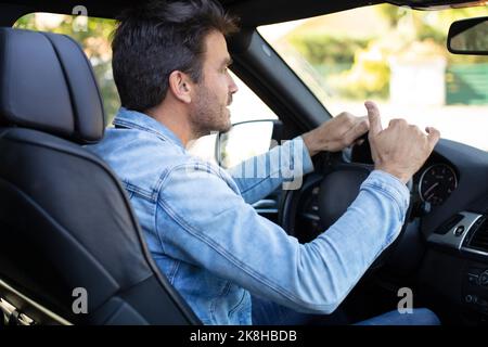 man in suit driving car Stock Photo