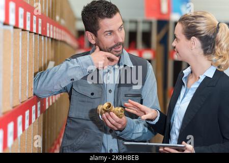 woman and man working in warehouse doing an invertory Stock Photo
