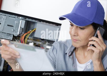 female engineer repairs the laptop Stock Photo