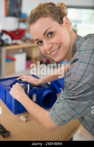happy female engineer testing circuit board Stock Photo