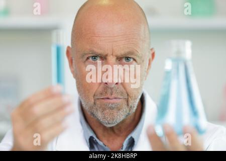 serious mature scientist working in laboratory Stock Photo