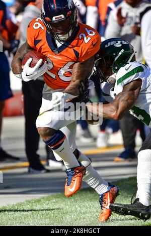 Denver Broncos running back Mike Boone (26) is hit by Indianapolis