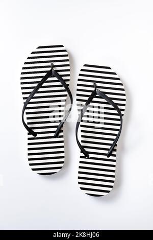 Pair of black and white stripe flip flops isolated on white background ...