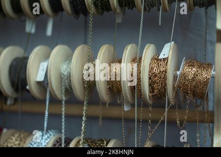 Chain decoration on coils. Sale of jewelry. Chains wound on reels ...