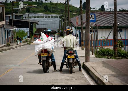 Filandia, Quindio, Colombia - June 5 2022: Two Colombian Men on Motorcycles Waiting for the Signaling Change to Continue on their Way Stock Photo