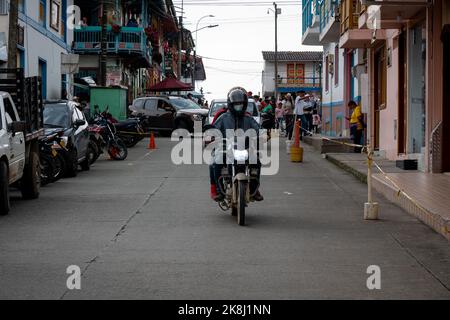 Filandia, Quindio, Colombia - June 5 2022: Colombian Man Rides on a Motorcycle in the Avenue Stock Photo