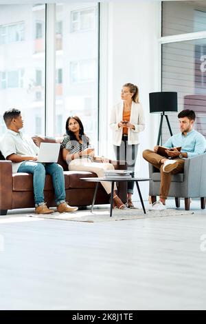 Time to brainstorm some big, new ideas. a group of businesspeople having a discussion in an office. Stock Photo