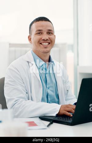 Making positive advances in the face of a pandemic. Portrait of a young scientist using a laptop while working in a laboratory. Stock Photo