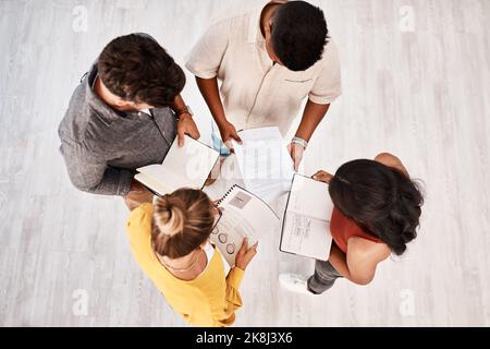 How well you succeed depends on how well you plan. High angle shot of a group of young designers having a discussion in an office. Stock Photo