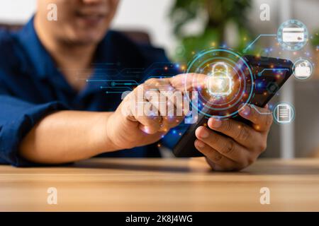 Asian Businessman using mobile smartphones and icon unlock network connections before assigning bank accounts, credit card, and confidential data. Cyb Stock Photo