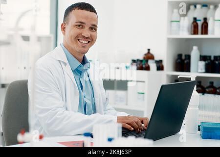 Rest assured, the remedy is on its way. Portrait of a young scientist using a laptop while working in a laboratory. Stock Photo