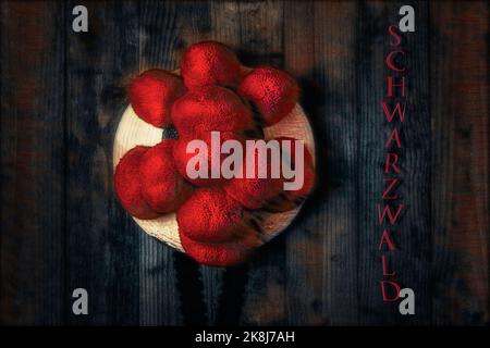 Original Black Forest Bollen hat in front of wooden wall in surrealistic style Stock Photo