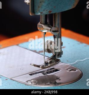 Sewing needle with thread on a sewing machine. Soft focus. Selective focus Stock Photo