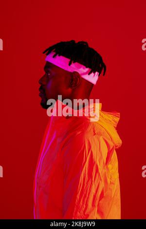 Dressed for the gym. Red filtered shot of a young sportsman posing in the studio. Stock Photo