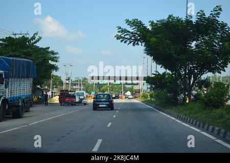 Vehicle passing through toll gate towards lower assam at National Highway 37 Stock Photo