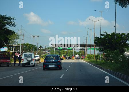 Vehicle passing through toll gate towards lower assam at National Highway 37 Stock Photo