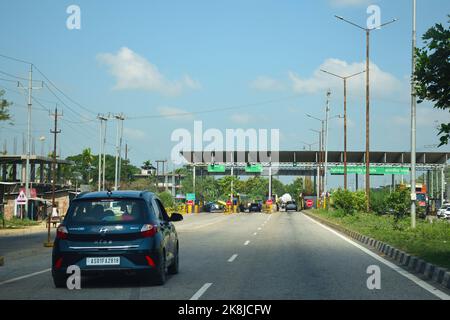 Vehicle passing through toll gate towards lower assam at National Highway 37 Stock Photo