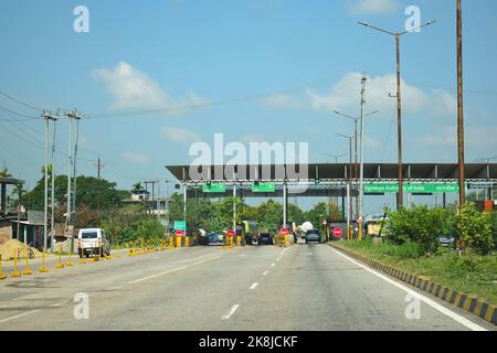 Vehicle passing through toll gate towards lower assam at National Highway 37 Stock Photo