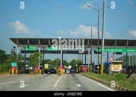 Vehicle passing through toll gate towards lower assam at National Highway 37 Stock Photo