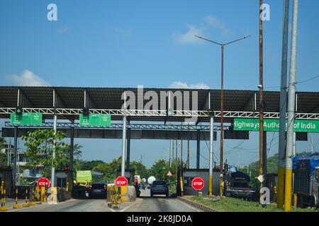 Vehicle passing through toll gate towards lower assam at National Highway 37 Stock Photo