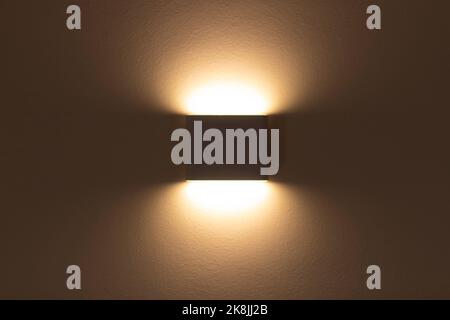 LED wall lamp close-up. Modern minimalistic bedside lamp for the bedroom Stock Photo