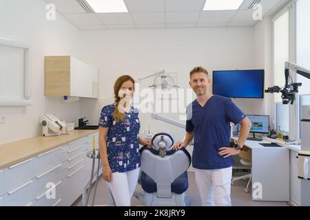 Portrait of dentist posing with nurse in dentists ambulance. Stock Photo