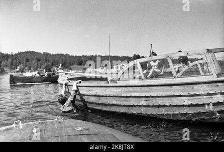 Hankø in the summer of 1956. Recording Norway's first feature film in color, titled 'Smugglers in tuxedo'. Here a man overboard, whether it was intentional, is not known .. Photo: Aage Storløkken / Current / NTB. Stock Photo