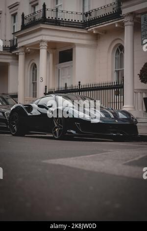 Blue Ferrari 488 pista showing off around London during a moody day. Parked in the richest districts of London. Stock Photo