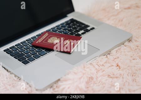 Russian Federation foreign passport on laptop keyboard. Prohibition of access to the Internet without passport data Stock Photo