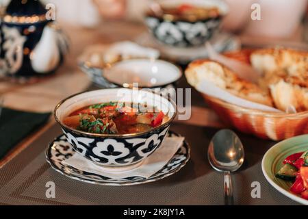 National Central Asian dish lagman, restaurant concept Uzbek food. High angle view of food in bowl on table. Stock Photo