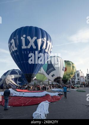 Sint Niklaas, Belgium, September 04, 2022, Hot air balloons are inflated and prepared for take off with many interested people Stock Photo