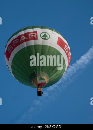Sint Niklaas, Belgium, September 04, 2022, The hot air balloon of the supermarket chain Spar high in the sky Stock Photo