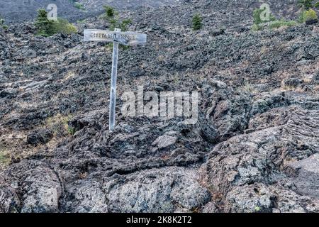 A sign at the entrance to the Grotta dei Lamponi (the Raspberry Cave), a spectacular lava tube beneath an old lava flow high on Mount Etna, Sicily Stock Photo