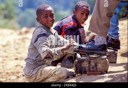 Ethiopia, Tigray; shoeshine boys are cleaning shoes from  customers. Stock Photo