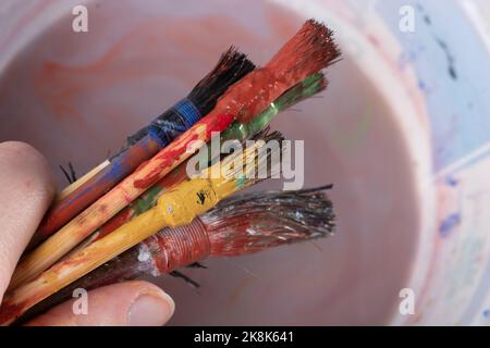 Paint brushes on technique ebru art on wooden background Stock Photo