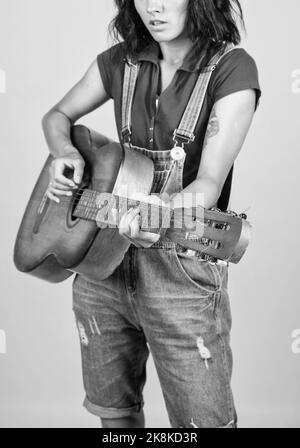 musical shop. country music style. attractive beauty with acoustic guitar. musical string instrument. female singer sing a song. happy woman play the Stock Photo