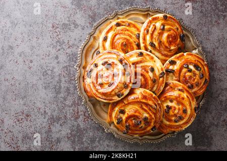 French traditional pastries Pains aux raisins closeup in the plate on the table. Horizontal top view from above Stock Photo