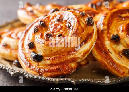 closeup of delicious freshly baked pain aux raisins closeup in the plate on the table. Horizontal Stock Photo